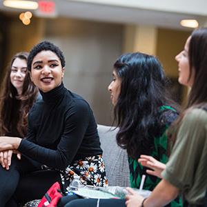 Girls talking, one in black shirt